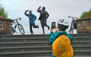 Cyclists at the Eric Morecambe Statue at Morecambe Prom Wildey Media